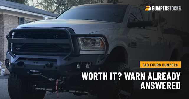 A customer's lifted white Ram 2500 in the driveway wearing a Fab Fours Matrix front winch bumper with a full grille guard