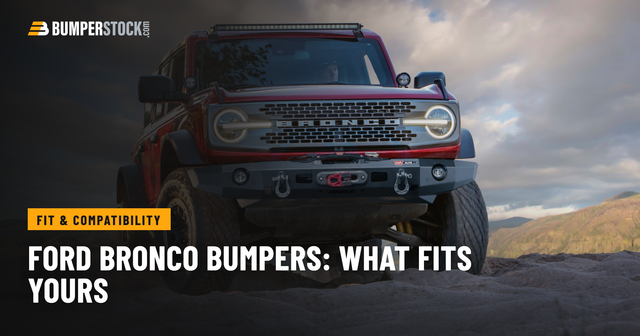 Red 4-door Ford Bronco with a Warn Elite steel front winch bumper on a sandy ridge