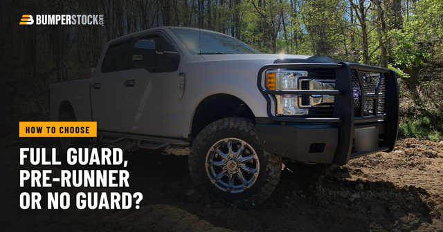 A customer's white Ford Super Duty with a Steelcraft Elevation front bumper and full grille guard, parked on dirt in the woods