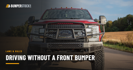 Red Ford F350 with a Ranch Hand Midnight steel front bumper on a paved country road