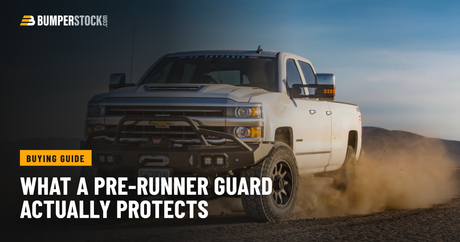 Chevy Silverado HD running a dirt road with a Warn Ascent front bumper and pre-runner guard, dust trailing behind.