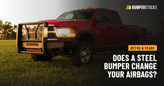 A customer's red Ram 2500 with a Steelcraft Elevation steel front bumper, parked on grass at sunset