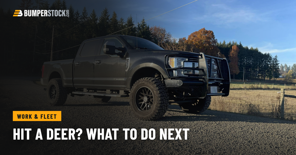 Ford F250 with a Steelcraft steel front bumper with a full grille guard, parked on a gravel road beside a fall pasture