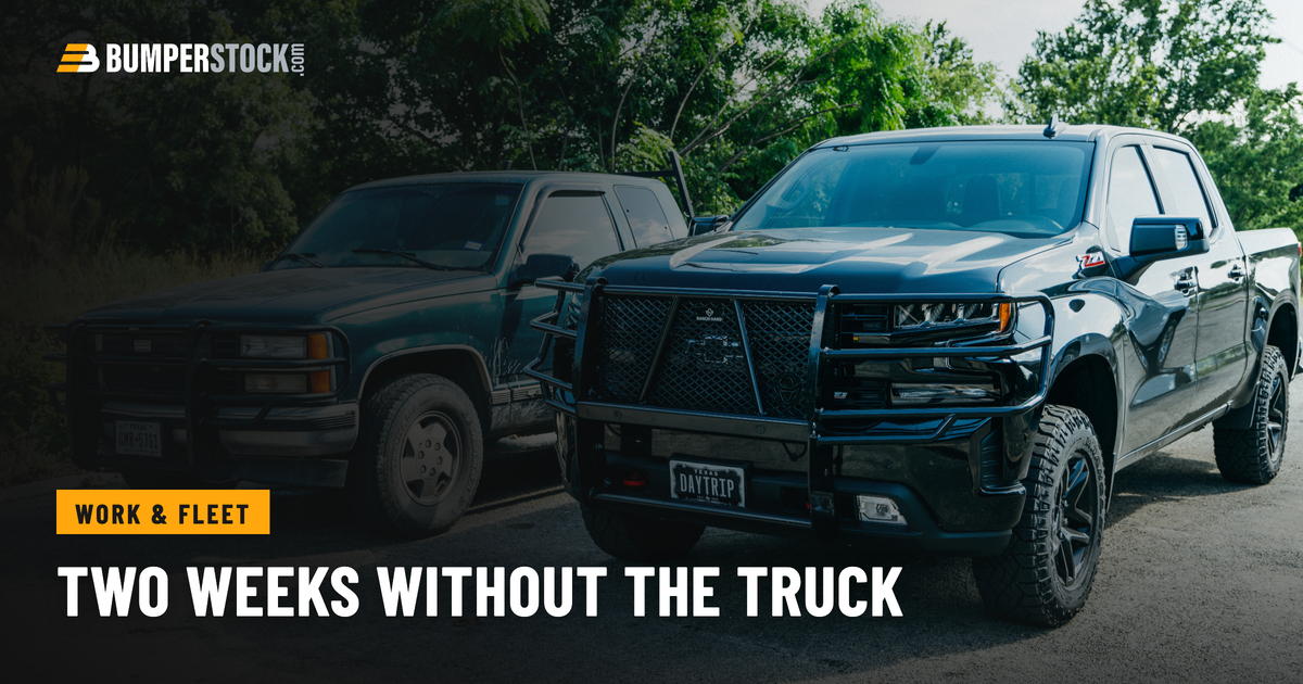 Two work trucks parked on gravel, both wearing steel front bumpers with full grille guards over the headlights